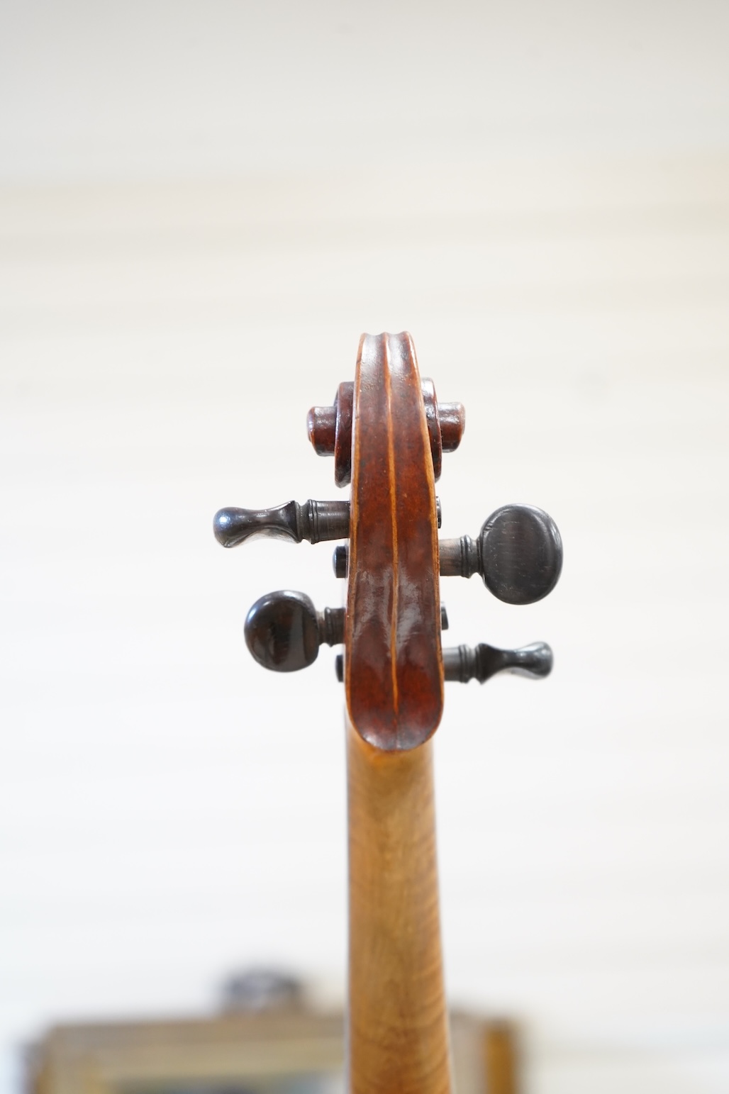 An early 20th century cased violin and cover, 60cm long